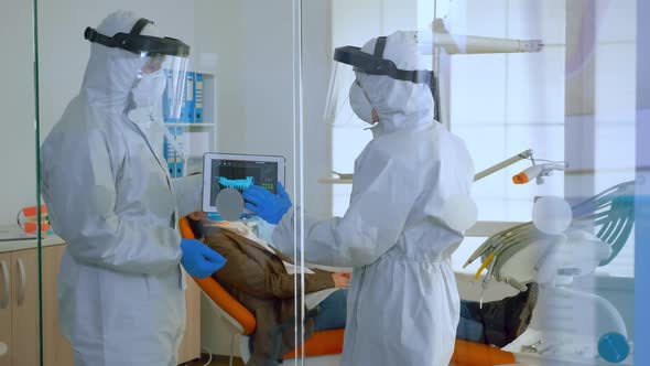 Team of Dentists Standing Near Patient Talking