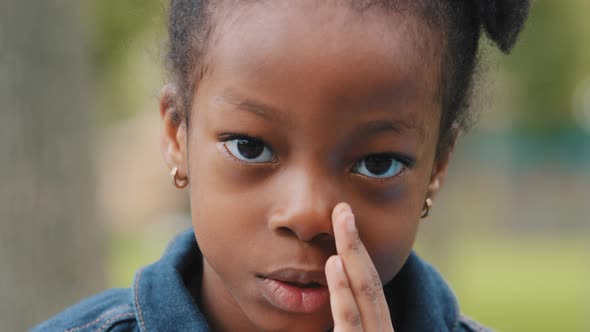 Cute Kid Telling Secret Quietly Closing Mouth with Hand Close Up African American Little Girl