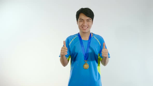 Man Thumbs Up With Gold Medal