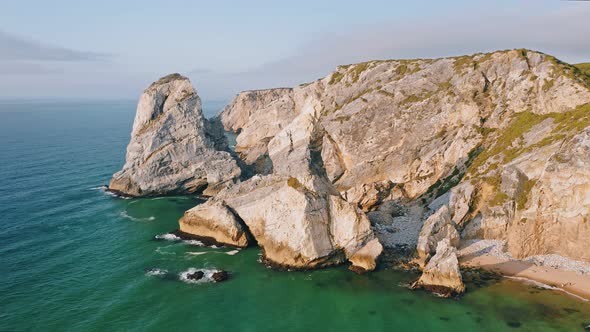 Aerial Drone View of Praia Da Ursa Beach in Sintra Portugal in Sunset Golden Hour Light