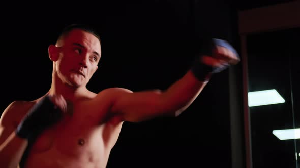 MMA Fighter Man Trains with Kickboxing in the Gym