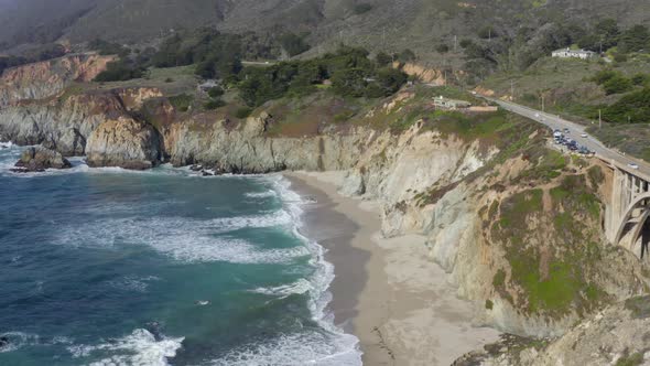 Pan from Bixby Creek Bridge on State Route 1 to an Aerial View of Big Sur Coast