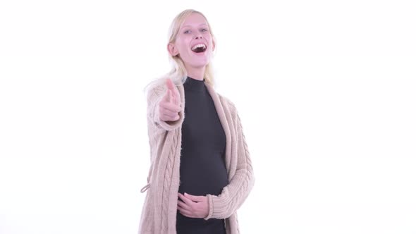 Happy Young Blonde Pregnant Woman Pointing at Camera