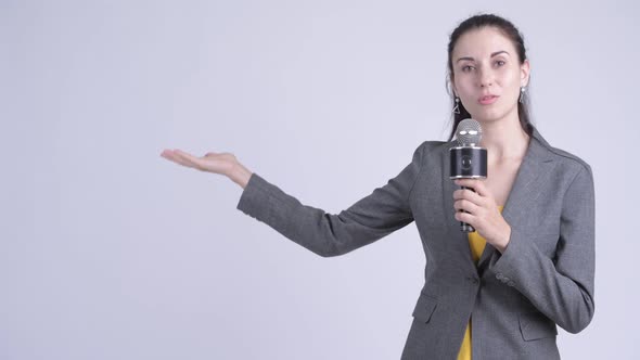 Happy Young Beautiful Businesswoman As Newscaster Presenting Something