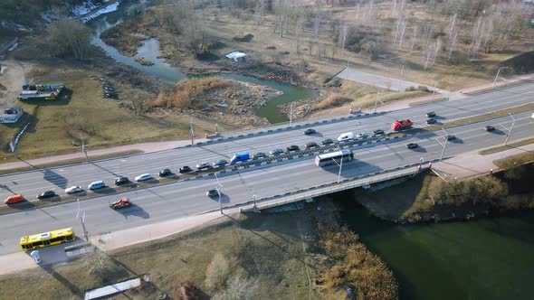 Suburb of a big city. City Park. City highway with busy traffic. Spring cityscape. Aerial photograph