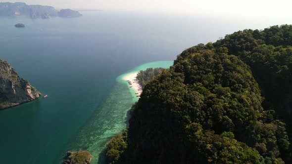 high altitude aerial of tall limestone mountains on Ko Poda Island revealing the tropical white sand