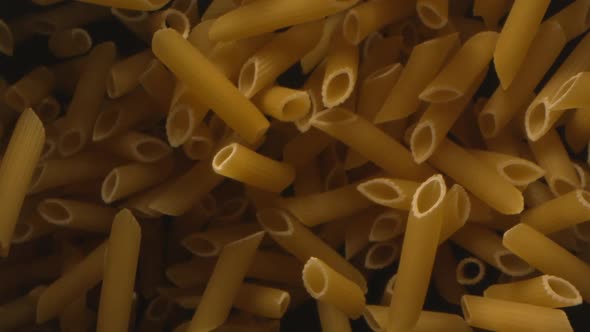 Pasta Penne Is Tossed In The Air In Slow Motion