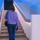 A Young Woman Walks Up the Stairs - VideoHive Item for Sale