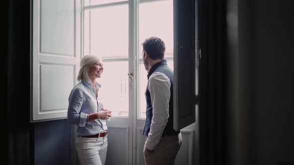 Two business people talking by the window