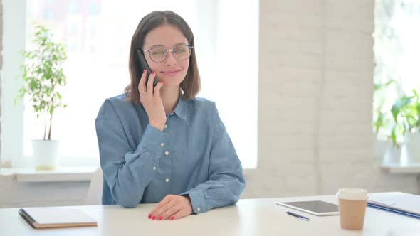 Young Woman Talking on Phone in Office