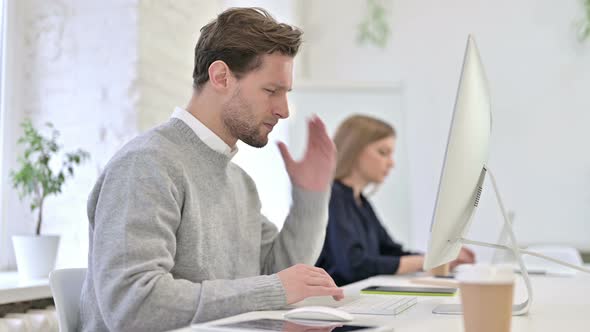 Tired Creative Male Professional Having Headache in Office