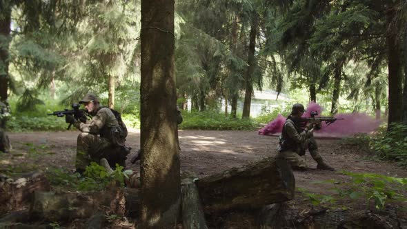 Side View of Soldiers Waiting for Evacuation with Injured Serviceman alt