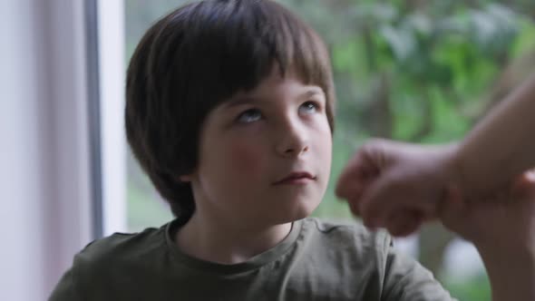 Closeup Confident Little Boy Stops Fist Looking at Camera with Serious Facial Expression