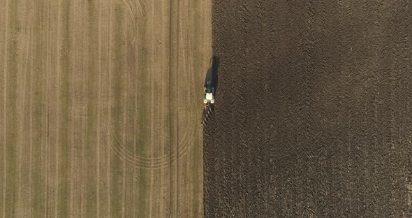 Top-down Aerial View of Tractor Plowing Field