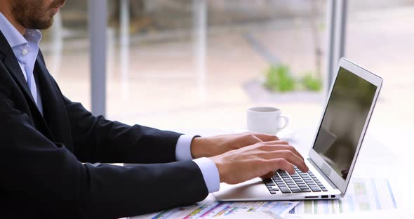 Tired businessman resting head on laptop at desk 4k