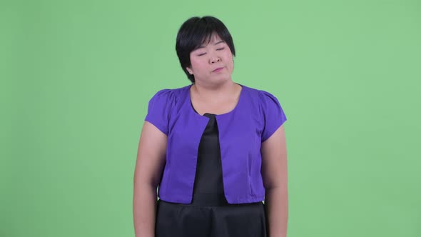 Stressed Young Overweight Asian Woman Looking Bored and Tired