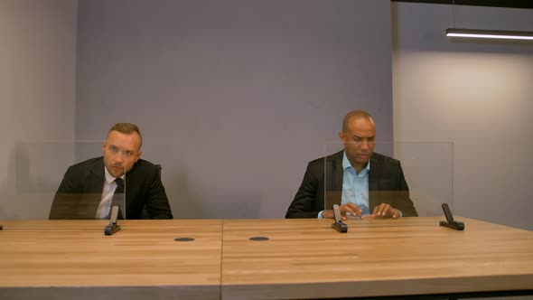 Two Colleagues Behind Empty Glass Futuristic Displays