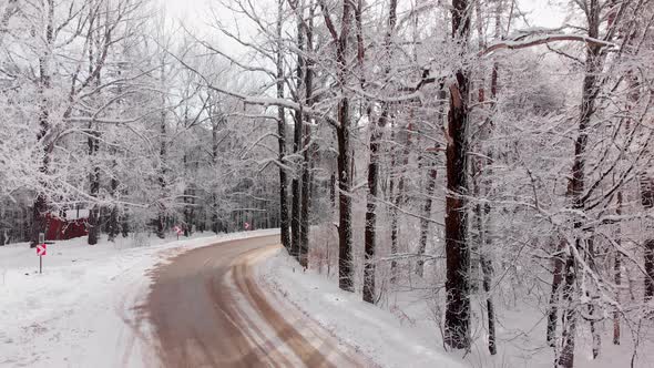 Zoom Out View Winter Road In Forest With Cabin