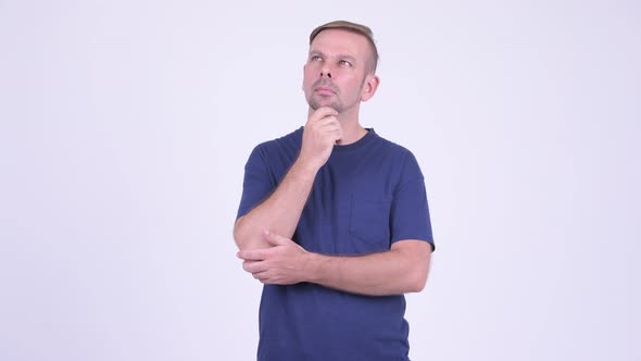 Portrait of Blonde Man Thinking While Looking Up