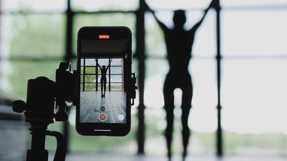 Young Attractive African American Woman Blogger Recording Video with a Smartphone Live Streaming