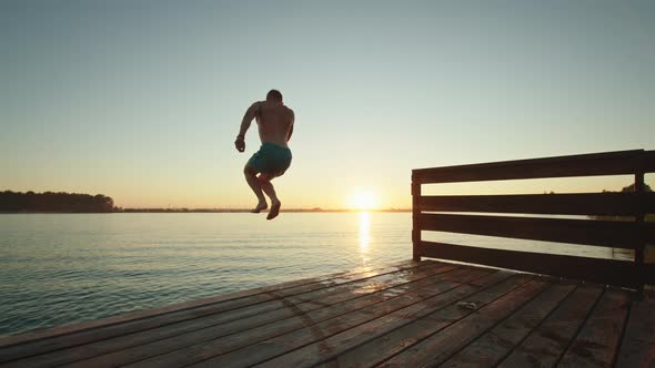 A Young Man is Jumping Into the Lake