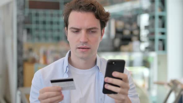 Portrait of Creative Man with Successful Online Payment on Smartphone