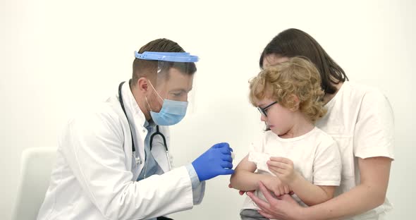 Mother with Kids Vaccinating at Pediatrician Office