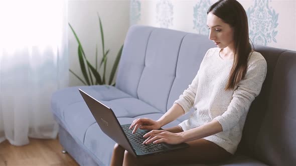 Woman Working From Home with Laptop