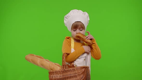 Child Girl Chef Cook Showing Basket with Baguette and Bread Smiling Sniffing on Chroma Key