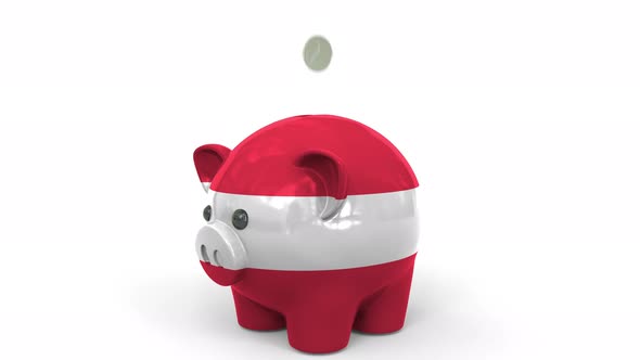 Coins Fall Into Piggy Bank Painted with Flag of Austria alt