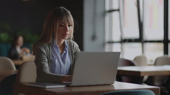 Online Work at the Laptop of an Asian Woman on Campus