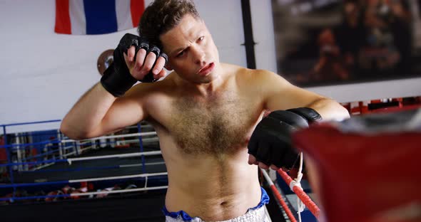 Tired male boxer standing in the ring