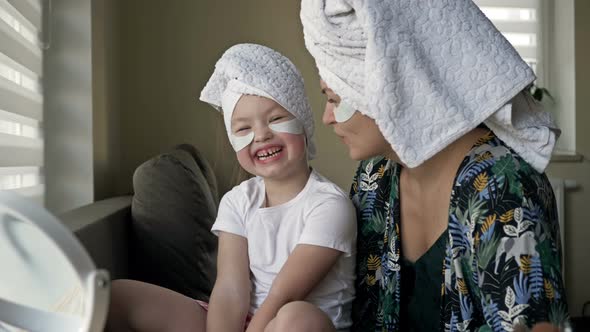 Young Woman and Her Little Daughter Are Doing Beauty Treatments After a Shower