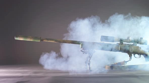 Sniper Rifle with Silencer on Black Background.