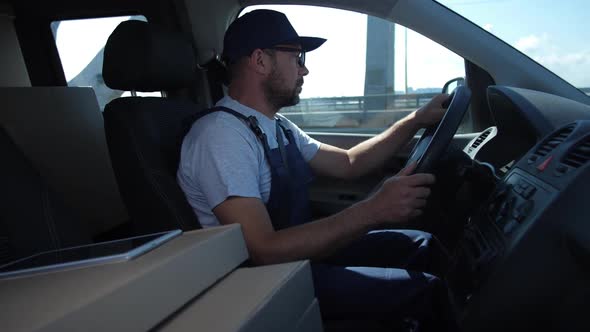 Confident Delivery Man Driving Car Around City