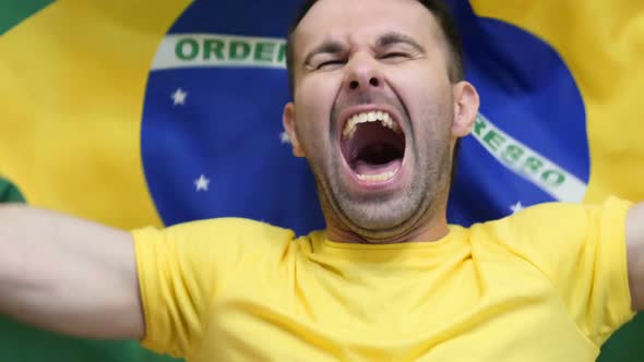 Brazilian Fan Celebrates Holding the Flag of Brazil