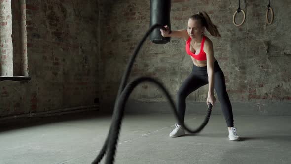 Young Fit Sportswoman Working Out in Fitness Training Gym