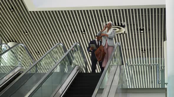 Young business people on an escalator in a modern building