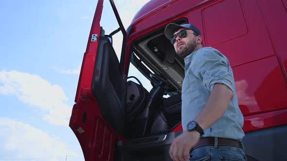 Caucasian Trucker in His 30s Getting Into Modern Semi Truck Cabin. Trucking Theme.