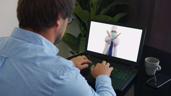 Senior Male Doctor Wears White Medical Coat, Stethoscope, Headset Makes Distant Video Call. Old