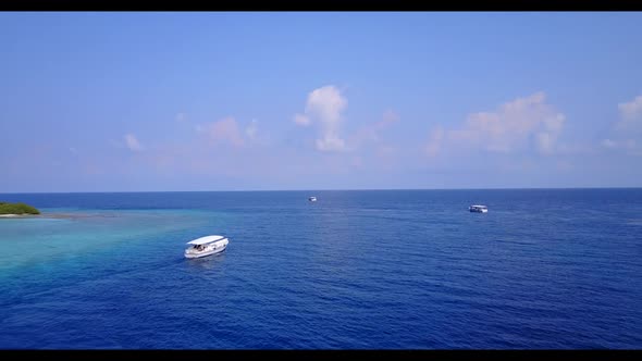 Aerial view scenery of exotic coastline beach wildlife by turquoise water with white sandy backgroun