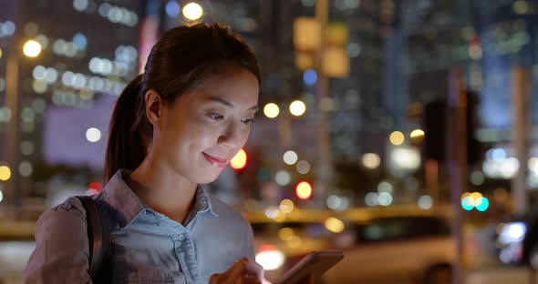 Woman Use Mobile Phone in City at Night