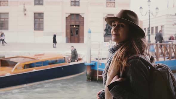 Cinematic Shot of Happy Young Beautiful Tourist Woman Enjoying Atmospheric Boat Trip Along City