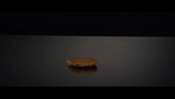 Falling cookies from above onto a reflective surface