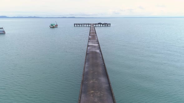 Drone shot of a pier leading into the sea. FLY FORWARD.