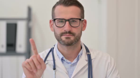 Portrait of Male Doctor Showing No Sign with Finger
