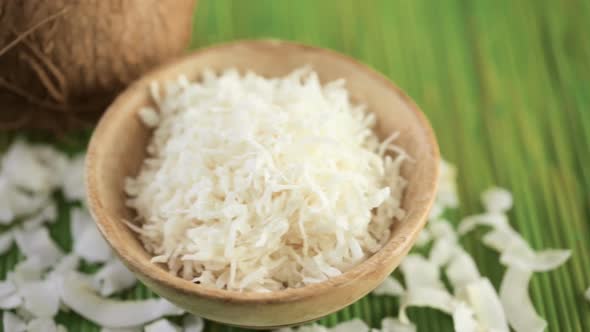 Dehydrated coconut flakes on a wood background