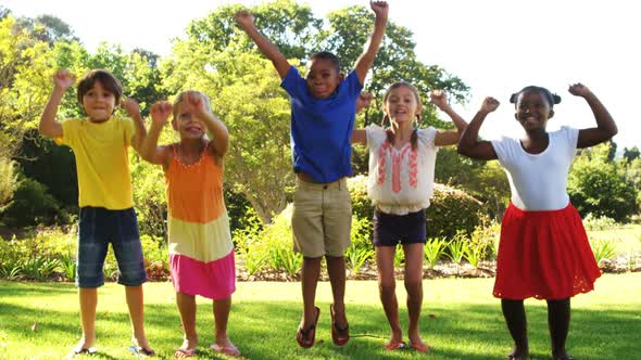 Group of kids jumping together in park