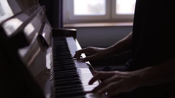 Closeup of Male's Hands Practicing to Play the Piano at Home
