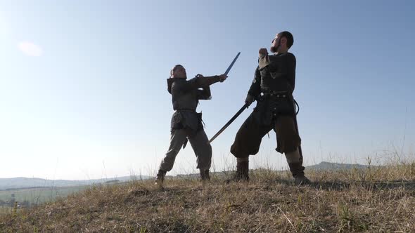 Brave medieval men fighting on a hill